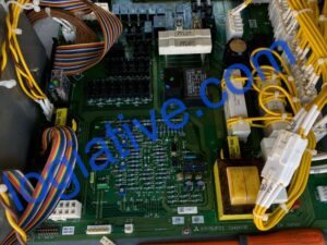 Close-up of a computer motherboard inside a chassis, with yellow power cables and multi-colored ribbon cables connected to sockets.